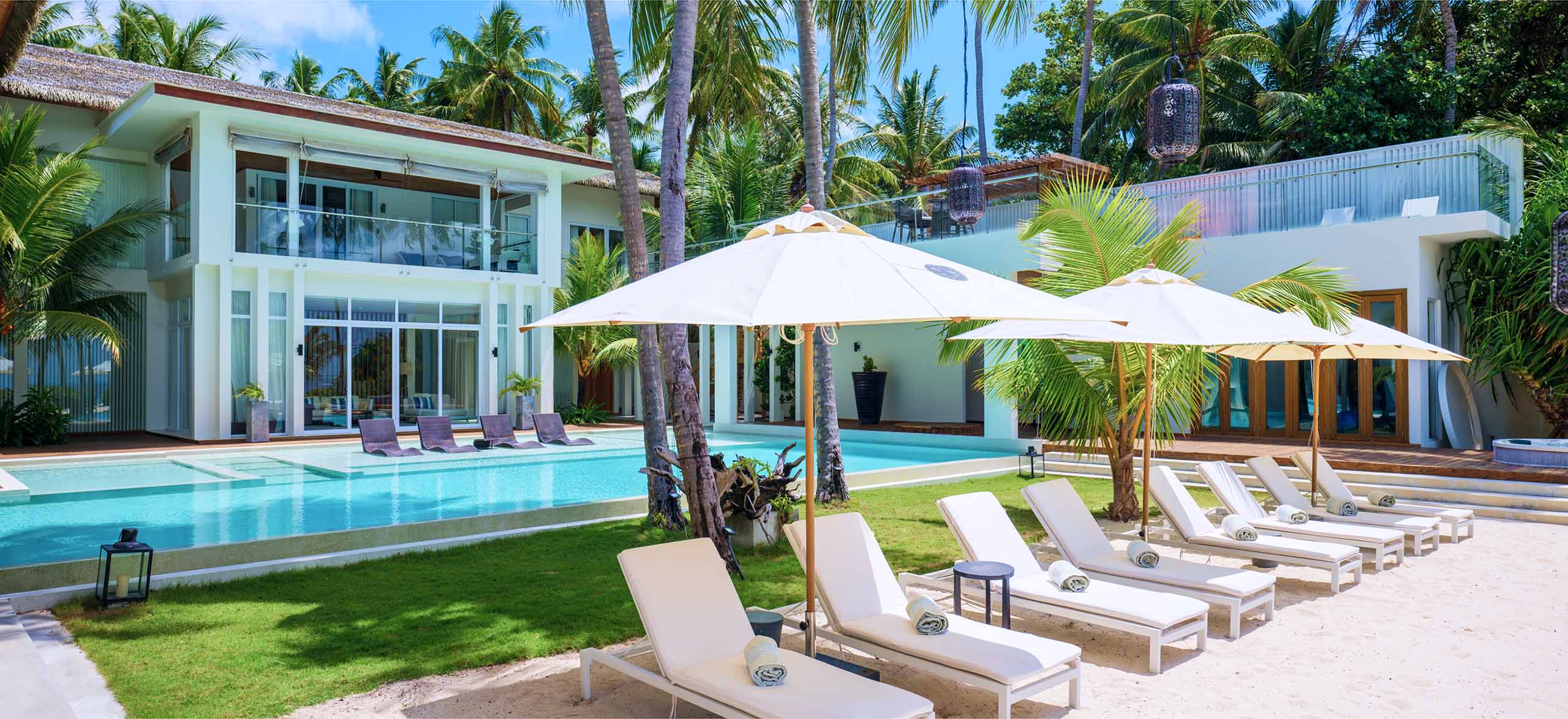 A poolside view of the Amilla Estate - The Mansion in the Maldives