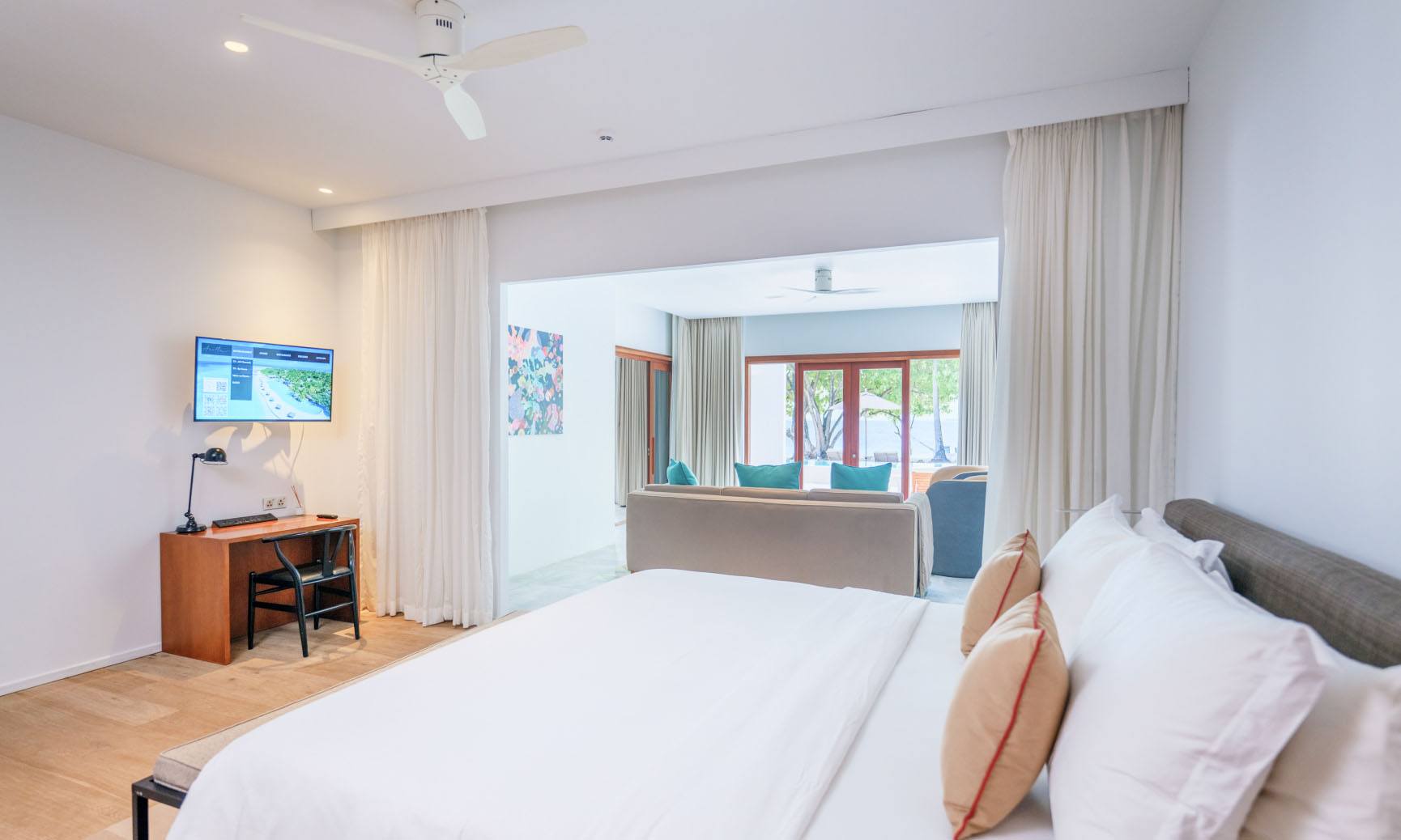 A bedroom with 1 king bed inside of our 2 bedroom villas with pool.