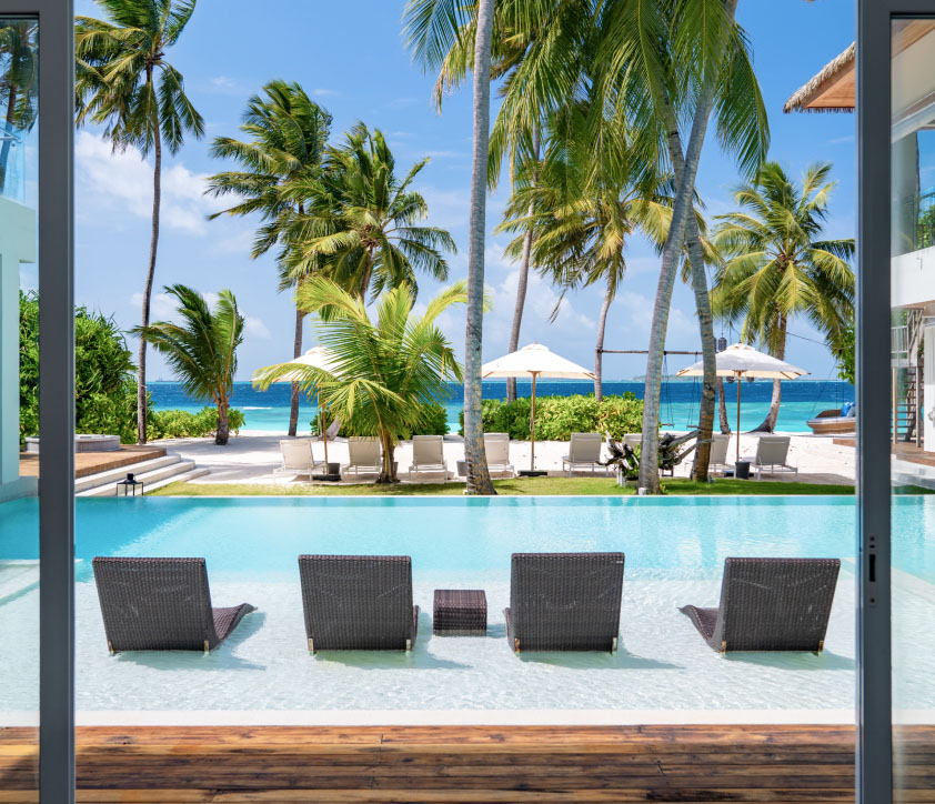 The private freshwater pool and in pool lounge chairs at our Mansion in the Maldives.