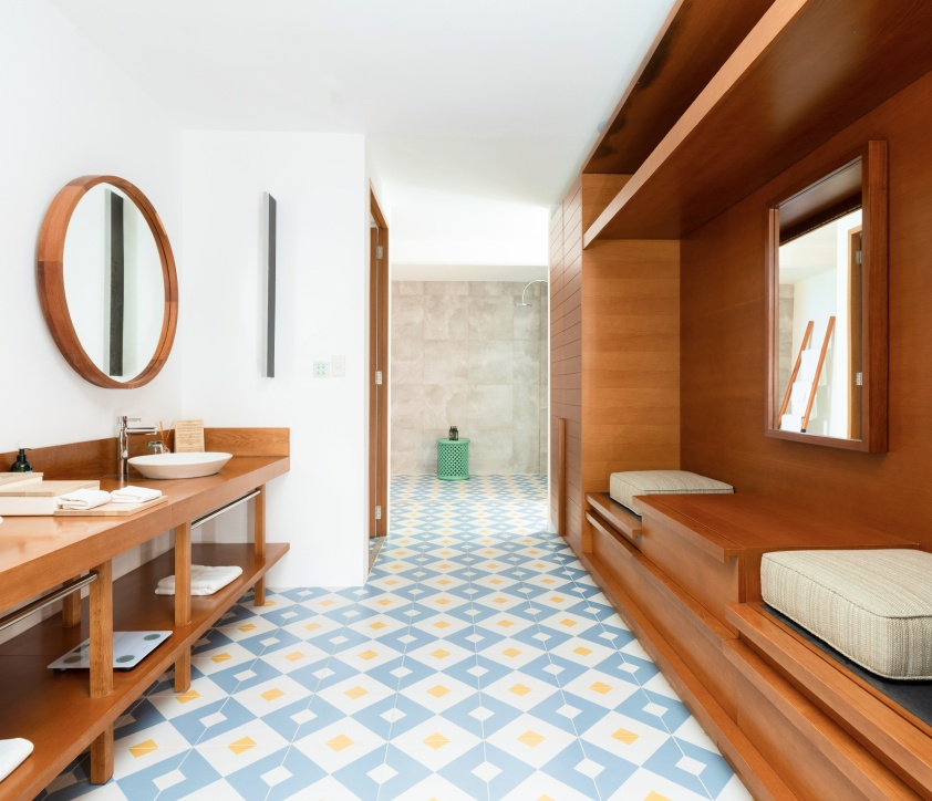 The expansive full bathroom with double sinks and seating area inside our Great Beach Residences Maldives.