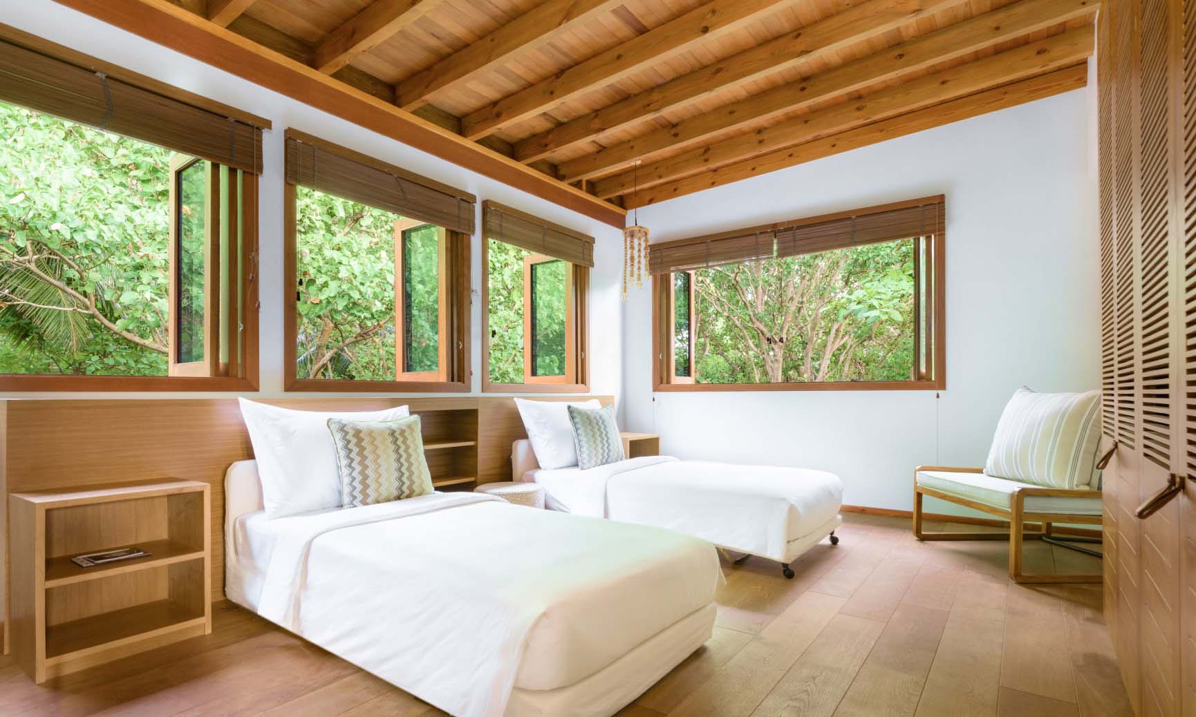 The bedroom with 2 single beds of the bedrooms inside of our Maldives Luxury Villas.